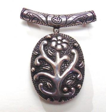 sterling silver oval locket decorated in a floral design by Victoria of Taxco