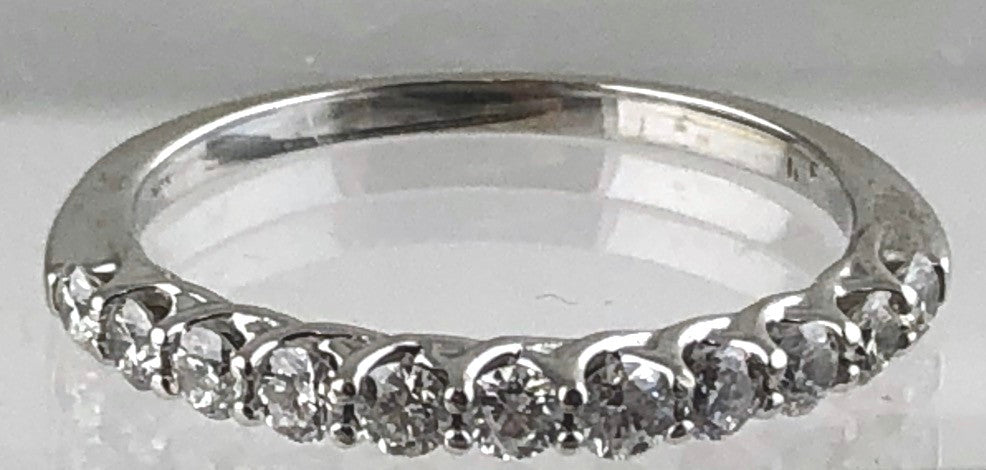 14kt white gold tapering band set with a total of eleven round brilliant cut diamonds